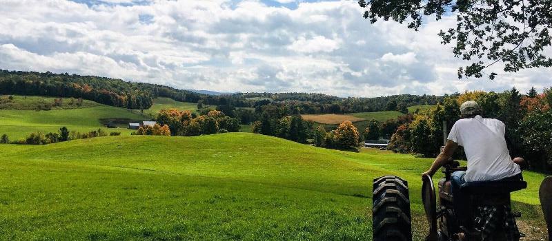 Brad Wiley on tractor at Otter Creek Farm